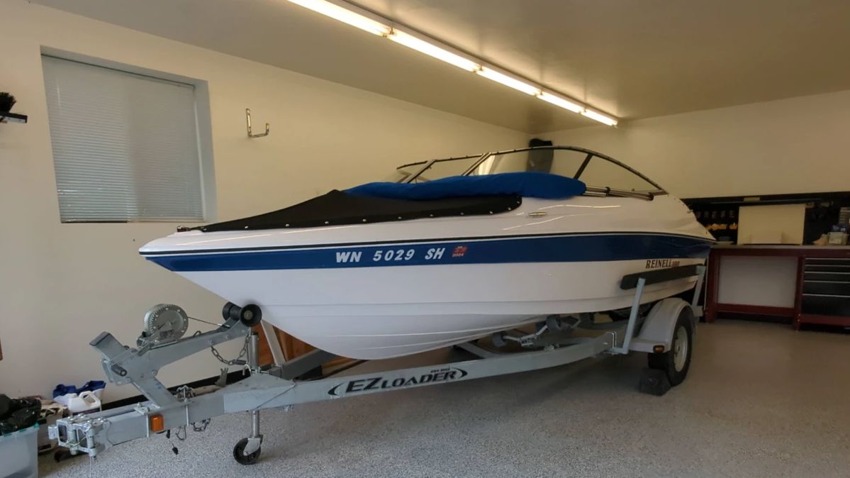  001 Reinell 180 Power Boat with EZ Loader Trailer, Suzuki 115 Motor, Bimini Top, and Boat Cover.