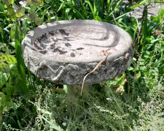 several concrete bird baths