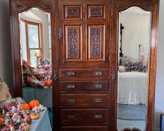 antique carved double armoire with mirrors