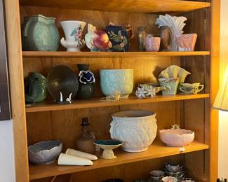 Shelves of pottery including much McCoy, Bill Campbell, Roseville, Cowen and many studio pieces. 