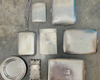 Vintage sterling cigarette holders, match striker and chained purses