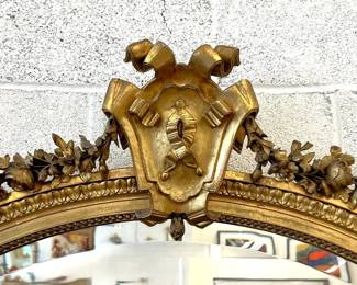 Very large antique French gilt mirror with shield crest and floral swags