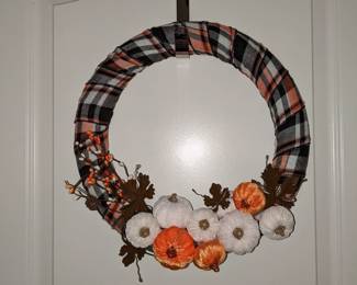 styrofoam wreath wrapped in plaid ribbon with brass leaves and velvet pumpkins