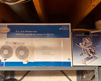 Back in the basement - the shelves are filled with great MINT IN THE ORIGINAL BOX ITEMS! Like the Window Fan on the left and the Photo Album on the right! BOTH UNUSED! 