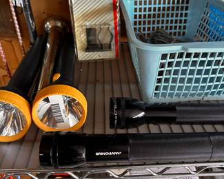 Shelving units are also filled with many unopened and NEW garage items! This shelf is FILLED with Flashlights of EVERY kind and price point! 