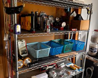 Shelving units are also filled with many unopened and NEW garage items! This shelf is FILLED with Flashlights of EVERY kind and price point! 