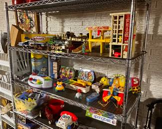 This is an entire rack of vintage to new toys and games!