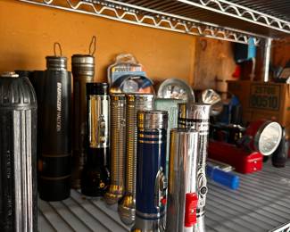 Shelving units are also filled with many unopened and NEW garage items! This shelf is FILLED with Flashlights of EVERY kind and price point! 