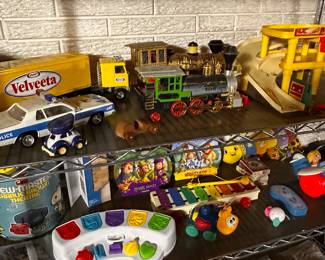 This is an entire rack of vintage to new toys and games!