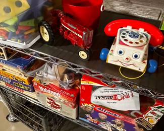 This is an entire rack of vintage to new toys and games!