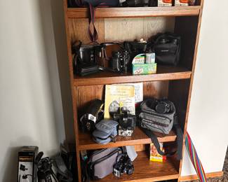 This is an entire shelf of Cameras, Camcorders, VINTAGE to MODERN, Binoculars, etc....