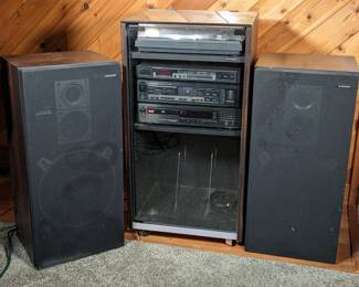 Lot 124: Pioneer stereo components to include rolling cabinet and floor speakers; speakers measure 31.5 " high x 15 " wide 