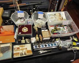 Large selection of jewelry, military medals, unique pins, tie pins, necklaces, bolo ties, Fenton perfume bottle, watches, gun cane, patches, Lalique, and more!