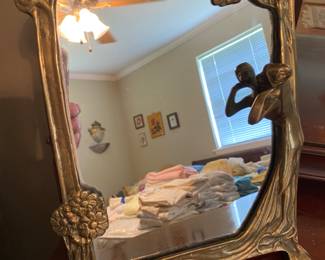 Heavy MCM brass lady in the looking glass dresser mirror.
