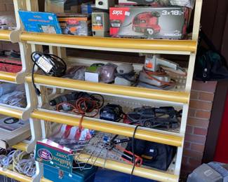 Lots of power tools on smaller rolling shelf
