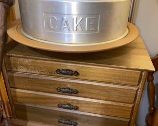 Hey SIL, here is another cake taker if the other one is not the right size and shape! It even has a lazy Susan base. It is sitting on a 4 drawer wooden silverware chest.