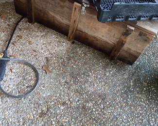 Primitive wood storage trunk with rope handles.