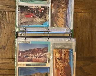 Thousands of vintage post cards arranged in over 30 binders.
