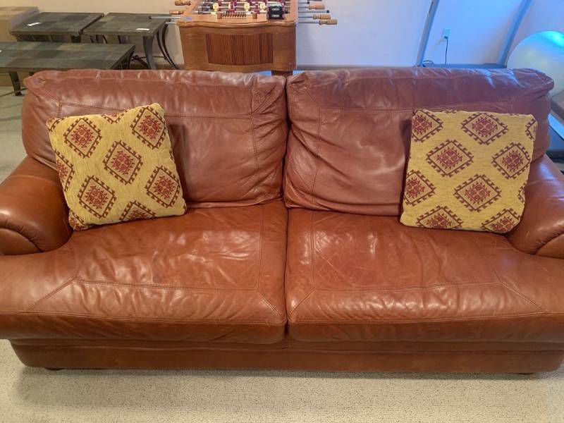 Leather sofa. Oversized. Bought from Furniture Row. Matches lots 1001, 1002 and 1003. Bring help to load it. It's located in the basement