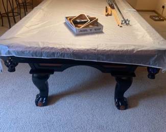 Legacy Billiards pool table 31x99x54. With cover, pool sticks, stick holder, racks, balls, chalk and brushes. Bring help to load. Located in the basement