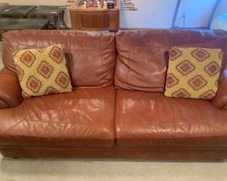 Leather sofa. Oversized. Bought from Furniture Row. Matches lots 1001, 1002 and 1003. Bring help to load it. It's located in the basement