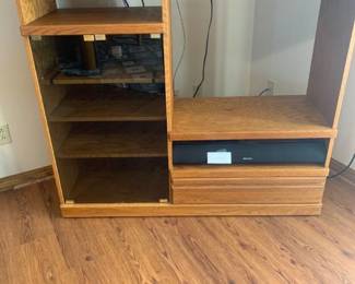 Wooden entertainment center with glass front and drawer. 45 x 52 x 16.5. Doesnât include t.v. or speaker