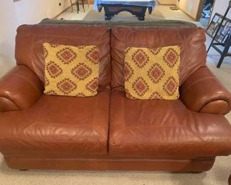 Leather loveseat. Oversized. Bought from Furniture Row. Matches lots 1000, 1001 and 1002. Bring help to load. Located in the basement