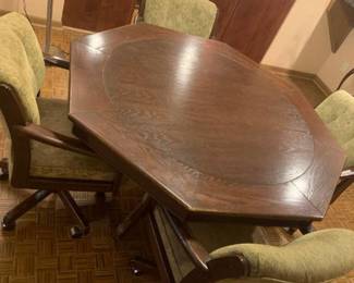 Octagon shaped wooden table with 4 chairs on wheels. Some wear on both table and chairs. See pictures. 31x64x64. Bring help to load. Located in the basement