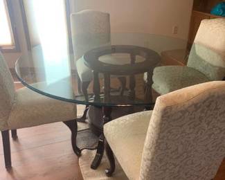 Round glass dining room table with 4 chairs. 30 x 60. Top has a chip. See pictures