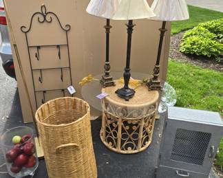 Lamps, woven basket, towel rack, wall mount metal storage unit, glass top rattan table, glass urn with apples, shell lamp