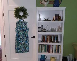 Bookcase, books & collectibles in green bedroom 