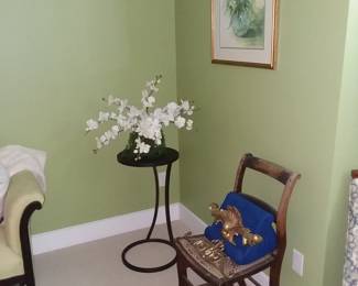 Antique chair and plant stand in green bedroom 