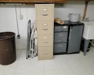From L to R. A garbage can, a few folding step ladders, a tall and proud four drawer file cabinet, and a really cool three drawer, one door file cabinet