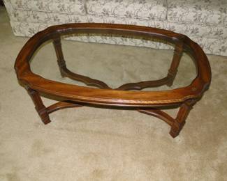 Glass insert wood coffee table with fine detailing on the legs