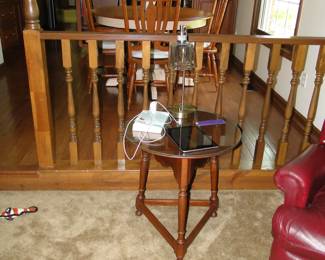 Small glass top table with wooden legs