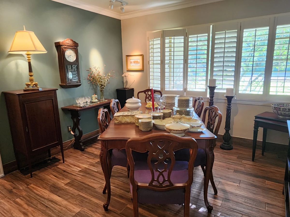 All wood dining table with 8 chairs (2 arm chairs), antique storage cabinet, wall pendulum clock