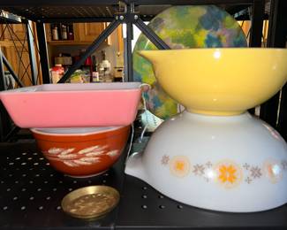 Vintage Pyrex bowls including a hard-to-find pink refrigerator dish, Harvest mixing bowl and set of three Cinderella bowls (smaller orange bowl sitting inside yellow bowl).
