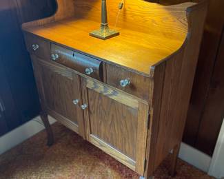 Petite  sideboard that adds some warmth to a room 