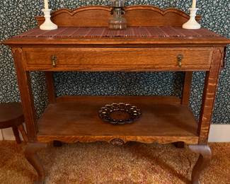 Really nice sideboard with beautiful  honey oak wood grains….little
deviled egg carnival plate underneath 