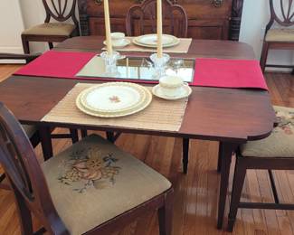 double drop-leaf mahogany table, set of 6 needlepoint seat chairs-one captain's chair and five side chairs