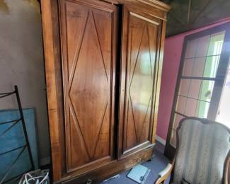 Very large palace sized french amor with diamond shaped doors.  This measure is amar measures over 100" tall 60" wide and 25" deep.  With two shelves inside.