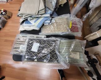 Several bolts of fabric banding for drapes in a pole strwe also have lots of decorative french remnants.