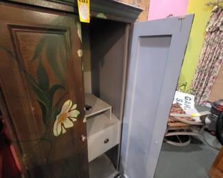 Interior of the small hand painted purple floral armoire from Mexico.