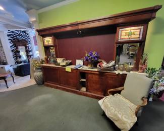 This is a 12 foot by 8 foot.Large bar back the interior section is big enough to house  80"+ t v.  Storage cabinets underneath travertine top and it's only 16" deep.