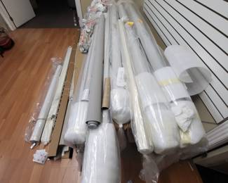 Huge motorized hunter douglas blinds sun screen blinds in white and Grey.  Retail for 2000 for sale ar 250.  Remotes are extra.  Sitting on top of an eight foot medium wood conference table.