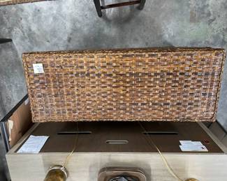 two large and deep woven wicker storage trunks