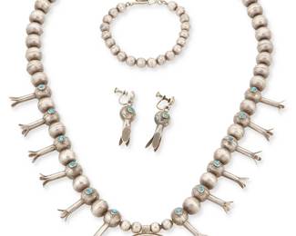 224
A Group Of Southwest-Style Silver And Turquoise Jewelry
Mid-20th century
Unmarked
A single strand sterling silver squash blossom necklace with tiny set turquoise cabochon blossoms and central naja (23.5 x 1.625" H), together with a pair of matching earrings (each: 1.75" H), and a small silver bead extender link (7" L), 4 pieces
101.8 grams gross
Estimate: $700 - $900