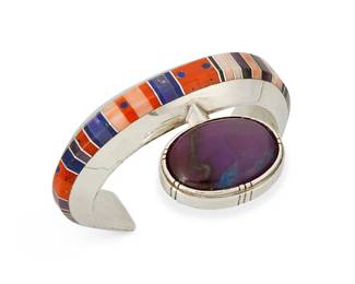 243
A Gibson Nez Navajo/Apache Stone Inlay Silver Cuff Bracelet
Gibson Nez (1947-2007, Jicarilla Apache/Diné)
Late 20th/21st century
Stamped: GZN
A chunky modernist sterling silver cuff with multistone channel inlay including coral, spiny oyster, sugilite, and lapis lazuli, and with an extended sugilite cabochon
6.125" total inner C x 1.875" H, with a 1.125" gap
104.9 grams gross
Estimate: $1,000 - $1,500