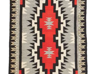 110
A Navajo Regional Rug
Mid-20th century, Diné
Woven in red, cream, light grey, and black wool with a stepped conjoined central diamond, sawtooth edges, stepped corners, and a complex border to two sides
55" H x 36.5" W
Estimate: $400 - $600