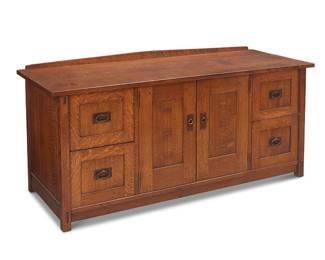 67
A Volpiani Workshop Arts & Crafts-Style File Cabinet
Late 20th century
Appears unmarked
The quarter sawn wood console cabinet with butterfly and mortis and tenon construction and copper pulls on hammered escutcheons, featuring two cabinet doors revealing a single adjustable shelf centering two opposed stacked file cabinets to each side, the top mounted with posterior gallery rail
31.5" H x 69.5" W x 25" D
Estimate: $600 - $800